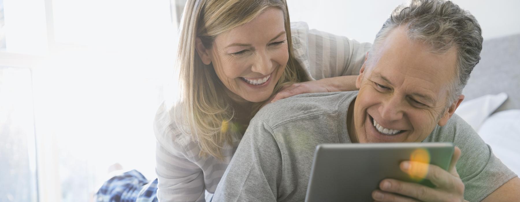 a woman and a man looking at a tablet